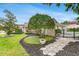 Beautifully landscaped front yard with a stone pathway leading to the home's entrance, showcasing lush greenery at 7032 Pelican Island Dr, Tampa, FL 33634