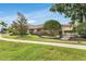 Charming home exterior featuring lush landscaping, a well-manicured lawn, and a welcoming front entrance at 7032 Pelican Island Dr, Tampa, FL 33634