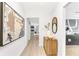 Bright hallway featuring wood-look flooring, modern art, and sleek cabinets, adding style and sophistication to the home at 7032 Pelican Island Dr, Tampa, FL 33634