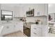 Bright kitchen with stainless appliances, white cabinets, and white countertops, creating a modern and clean aesthetic at 7032 Pelican Island Dr, Tampa, FL 33634