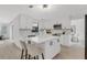 Modern kitchen with white cabinets, island with seating, and stainless steel appliances at 7032 Pelican Island Dr, Tampa, FL 33634
