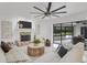 Cozy living room features a fireplace, large windows, and comfortable seating at 7032 Pelican Island Dr, Tampa, FL 33634