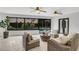 Inviting living room with wicker furniture, a view of the pool, and plenty of natural light at 7032 Pelican Island Dr, Tampa, FL 33634