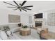 Spacious living room featuring a fan, fireplace, and neutral tones creating a cozy atmosphere at 7032 Pelican Island Dr, Tampa, FL 33634