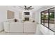Bright living room features a large sectional sofa, fireplace and expansive sliding glass doors at 7032 Pelican Island Dr, Tampa, FL 33634