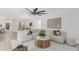 Open-concept living area with modern fan, leading into a dining room and kitchen, ideal for entertaining at 7032 Pelican Island Dr, Tampa, FL 33634
