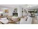 Open living room featuring modern furnishings and views to the dining area at 7032 Pelican Island Dr, Tampa, FL 33634