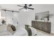 This main bedroom features a sliding barn door to the primary bathroom, an updated ceiling fan and hardwood floors at 7032 Pelican Island Dr, Tampa, FL 33634