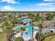 Expansive community pool area with palm trees and ample seating under a blue sky at 7103 Bridgeview Dr, Wesley Chapel, FL 33545