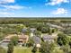 Wide aerial view of houses with lush green lawns, mature trees, and neighborhood ponds at 7103 Bridgeview Dr, Wesley Chapel, FL 33545