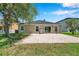 Spacious brick paver patio, perfect for outdoor entertaining, with a well-manicured lawn at 7103 Bridgeview Dr, Wesley Chapel, FL 33545