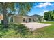 Spacious brick paver patio, perfect for outdoor entertaining, with a well-manicured lawn at 7103 Bridgeview Dr, Wesley Chapel, FL 33545