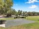An outdoor basketball court surrounded by trees in a community green space at 7103 Bridgeview Dr, Wesley Chapel, FL 33545