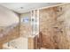 Bathroom showcases a tiled shower, garden tub, and neutral color palette at 7103 Bridgeview Dr, Wesley Chapel, FL 33545