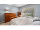 Bedroom with natural light and wooden dresser at 7103 Bridgeview Dr, Wesley Chapel, FL 33545