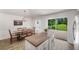 Cozy dining area with backyard views, modern lighting fixture, and access to the kitchen at 7103 Bridgeview Dr, Wesley Chapel, FL 33545
