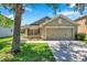 Charming single-story home with a well-maintained lawn, complemented by a two-car garage and inviting curb appeal at 7103 Bridgeview Dr, Wesley Chapel, FL 33545