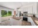 Modern kitchen with stainless steel appliances, island, and sliding glass doors to the backyard at 7103 Bridgeview Dr, Wesley Chapel, FL 33545