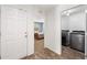 Bright laundry area features modern, stainless steel appliances and wood-look tile flooring at 7103 Bridgeview Dr, Wesley Chapel, FL 33545