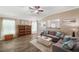 Comfortable living room boasting wood floors, a neutral color palette, and a ceiling fan for added comfort at 7103 Bridgeview Dr, Wesley Chapel, FL 33545