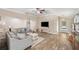 Comfortable living room boasts wood-look floors, neutral walls, comfortable couches, and good natural light at 7103 Bridgeview Dr, Wesley Chapel, FL 33545