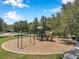 Outdoor playground featuring slides, climbing structures, and swings in a community park at 7103 Bridgeview Dr, Wesley Chapel, FL 33545
