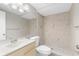 Bright bathroom featuring a tiled shower, modern vanity and neutral wall color at 7215 San Moritz Dr, Port Richey, FL 34668