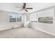 Neutral bedroom with carpet, ceiling fan, and natural light at 7215 San Moritz Dr, Port Richey, FL 34668