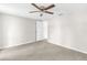 Large bedroom with neutral carpeting, ceiling fan, and open closet at 7215 San Moritz Dr, Port Richey, FL 34668