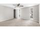 Spacious bedroom with neutral carpeting, two windows, and ceiling fan at 7215 San Moritz Dr, Port Richey, FL 34668