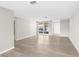 Bright living room with laminate flooring and a large window providing ample natural light at 7215 San Moritz Dr, Port Richey, FL 34668