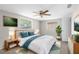 Comfortable bedroom with a queen bed, ceiling fan, and two windows with natural light at 7215 San Moritz Dr, Port Richey, FL 34668