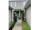 Covered entrance welcomes you with climbing vines and lush shrubbery at this charming townhome at 7838 66Th N Way, Pinellas Park, FL 33781