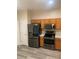 Kitchen featuring stainless steel appliances, wood cabinets, modern floors and light countertops at 7838 66Th N Way, Pinellas Park, FL 33781