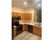 Modern kitchen featuring stainless steel appliances, wood cabinets and light countertops at 7838 66Th N Way, Pinellas Park, FL 33781