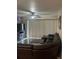 Living room with wood floors, a ceiling fan, and large brown leather couch at 7838 66Th N Way, Pinellas Park, FL 33781