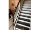 Carpeted staircase with wood railing at 7838 66Th N Way, Pinellas Park, FL 33781