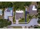 Aerial shot of houses with pools and palm trees, a street and well-maintained lawns at 80 Sycamore Ct, Palm Harbor, FL 34683