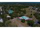 An aerial view of community amenities, including tennis courts and a sparkling pool at 80 Sycamore Ct, Palm Harbor, FL 34683