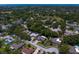 The neighborhood is seen from above, displaying how the houses are surrounded by trees at 80 Sycamore Ct, Palm Harbor, FL 34683