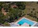 Aerial view showcasing the community pool, playground, and green spaces in a park-like setting at 80 Sycamore Ct, Palm Harbor, FL 34683