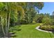 A spacious backyard featuring lush greenery and trees perfect for outdoor activities and relaxation at 80 Sycamore Ct, Palm Harbor, FL 34683