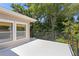 Outdoor balcony with neutral siding and a view of green trees at 80 Sycamore Ct, Palm Harbor, FL 34683