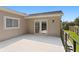 Outdoor balcony with neutral siding and a view of green grass at 80 Sycamore Ct, Palm Harbor, FL 34683