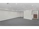A spacious basement with gray carpet, bright lighting, and a staircase for easy access to other floors at 80 Sycamore Ct, Palm Harbor, FL 34683
