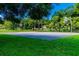 Basketball court with well-maintained surroundings in a community park at 80 Sycamore Ct, Palm Harbor, FL 34683