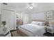 Comfortable bedroom features a ceiling fan, two closets, light-filled window, and a dedicated desk area at 80 Sycamore Ct, Palm Harbor, FL 34683