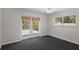 Cozy bedroom with dark grey carpet, natural light, and a private balcony entrance at 80 Sycamore Ct, Palm Harbor, FL 34683