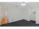 Neutral bedroom with dark carpet, white walls, a ceiling fan, and window at 80 Sycamore Ct, Palm Harbor, FL 34683