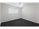 A bright bedroom with fresh paint, plush carpet, ceiling fan, and a bright window for natural light at 80 Sycamore Ct, Palm Harbor, FL 34683